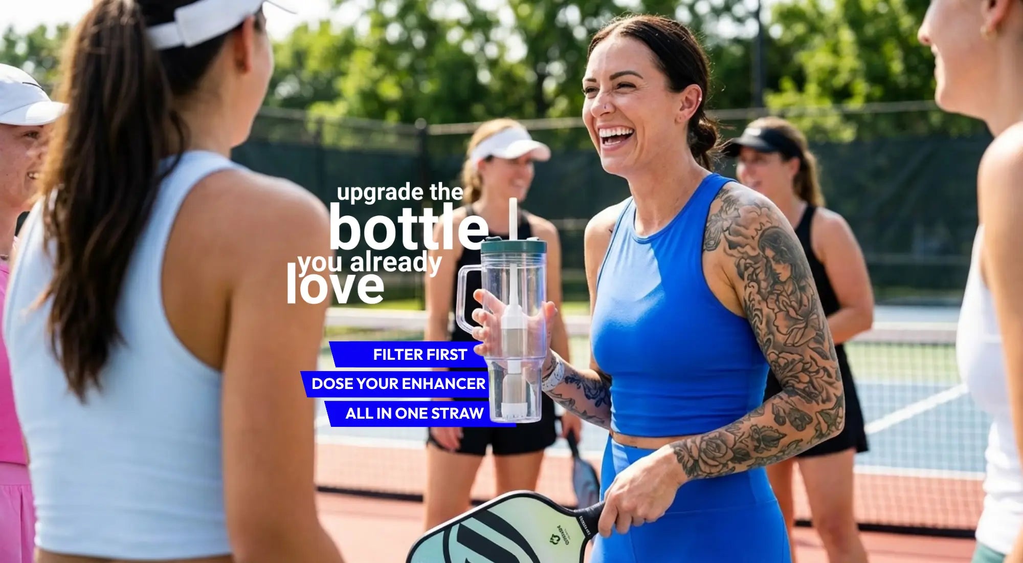 Woman on a padel court holding a water bottle 