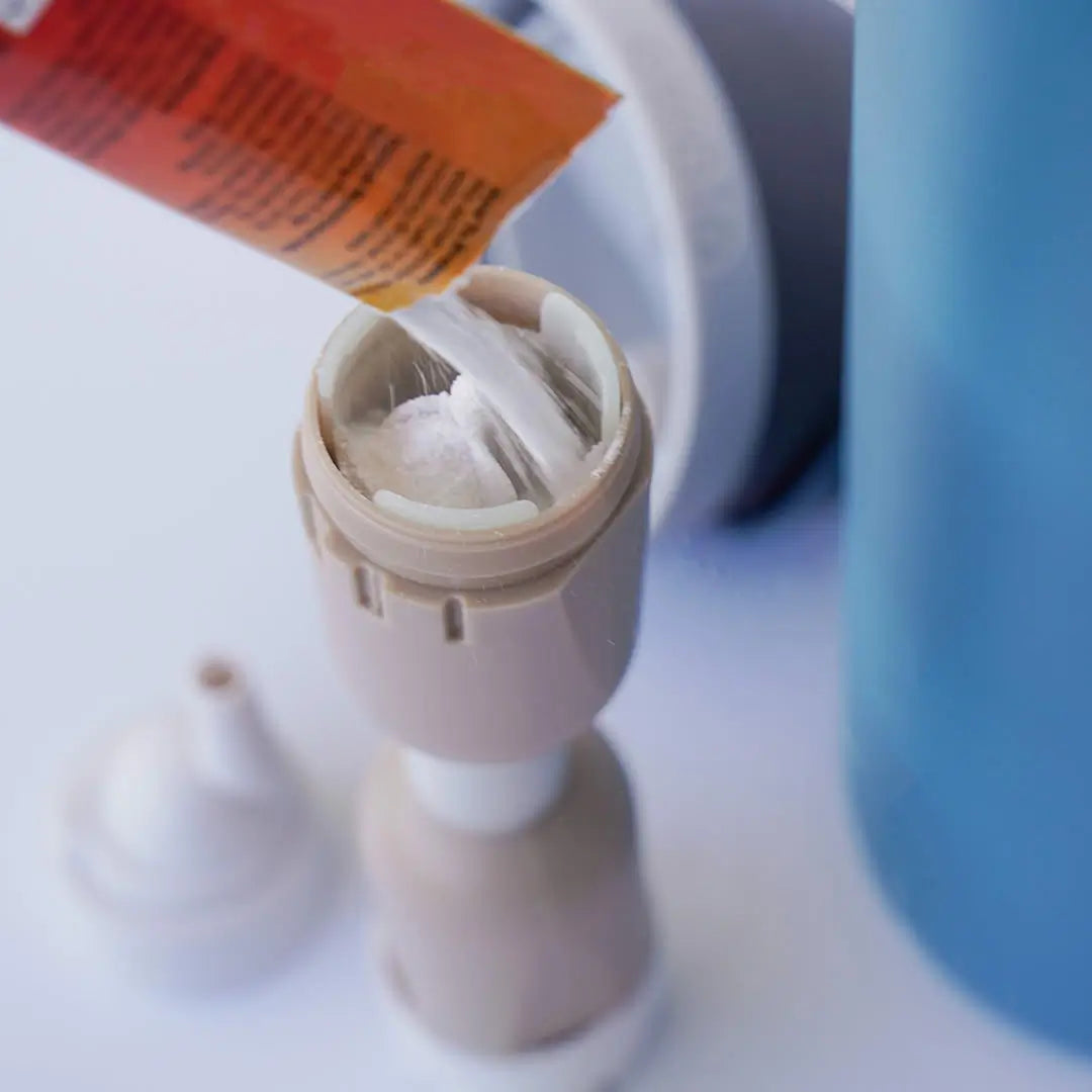 Close-up view of the Flava Chamber being filled with flavored powder or electrolytes.